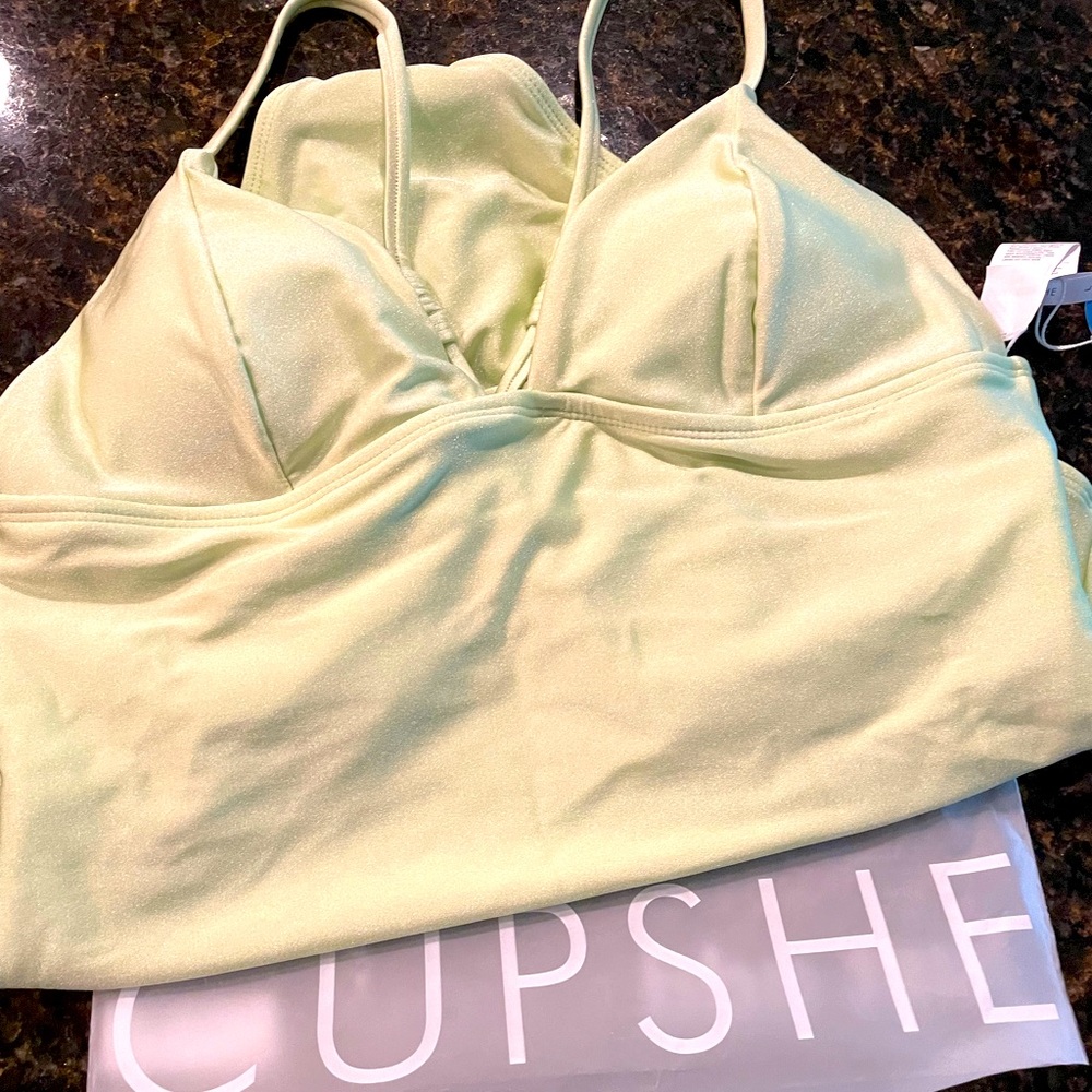 Neon green one-piece swimsuit with cheeky high-leg cut.